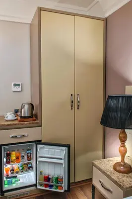 a kitchen with an open refrigerator in front of a door at Hotel Bossuite Kadikoy in Istanbul