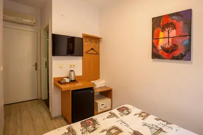 a hotel room with a bed and a desk and a bed and a room at Pera Sultan Suit in Istanbul