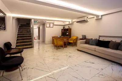 a living room with a couch and a table and chairs at Pera Sultan Suit in Istanbul