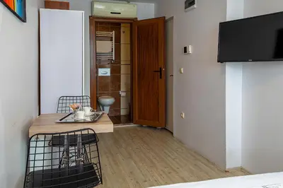 a living room with a table and a tv at Pera Sultan Suit in Istanbul
