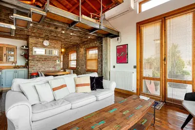 a living room with a white couch and a table at Alaattin Apartments in Istanbul