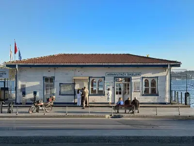 a white building with people sitting in front of it at Bosphorus Villa Arnavutköy 5BR for 12 Guests in Istanbul