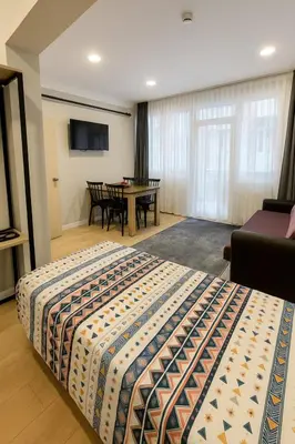 a bedroom with a bed and a table in a room at Sare Apartments - Sultanahmet in Istanbul