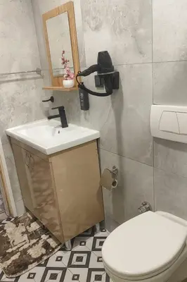 a bathroom with a white toilet and a sink at Sare Apartments - Sultanahmet in Istanbul