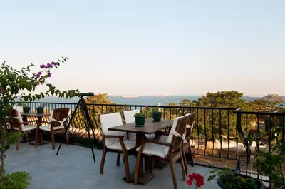 a patio with a table and chairs on a balcony at Queen Seagull Boutique Hotel in Istanbul
