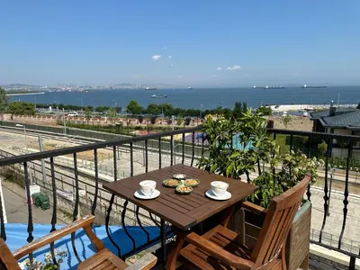 a table on a balcony with a view of the ocean at Queen Seagull Boutique Hotel in Istanbul