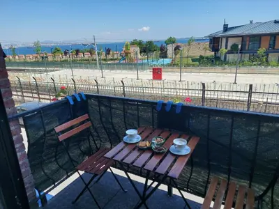 a wooden table with plates and cups on a balcony at Queen Seagull Boutique Hotel in Istanbul