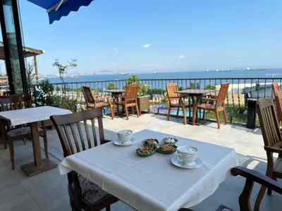 a table with cups and bowls on top of a balcony at Queen Seagull Boutique Hotel in Istanbul