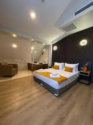 a bedroom with a large bed and a couch at Rota Business Hotel Gebze in Güzeltepe