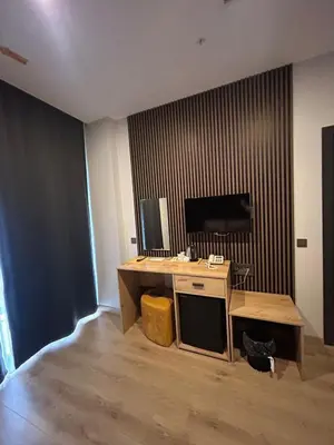a room with a desk and a television in it at Rota Business Hotel Gebze in Güzeltepe