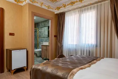 a bedroom with a bed and a window and a bathroom at The Ottoman apartment in Istanbul