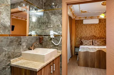 a bathroom with a sink and a bed in a room at The Ottoman apartment in Istanbul