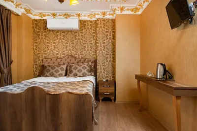 a bedroom with a bed and a desk and a television at The Ottoman apartment in Istanbul