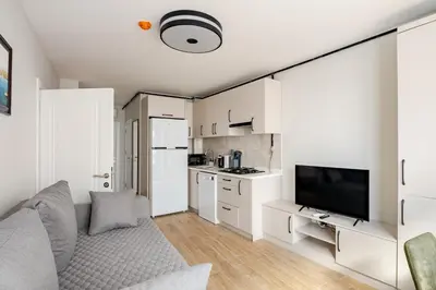 a living room with a couch and a kitchen at B Polat in Istanbul
