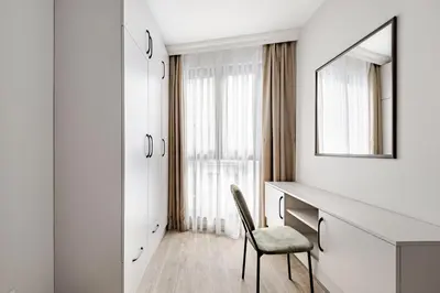 a bedroom with a desk and a mirror and a chair at B Polat in Istanbul