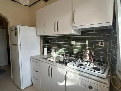 a kitchen with a stove and a white refrigerator at Karakaş Homes in Istanbul