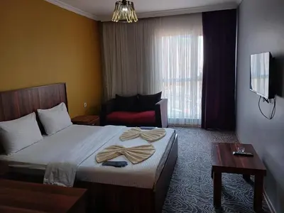 a hotel room with a bed with towels on it at Ay suit in Esenyurt