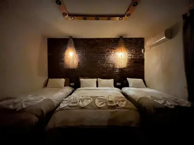 two beds in a room with lights on the wall at Wooden Villa in Istanbul