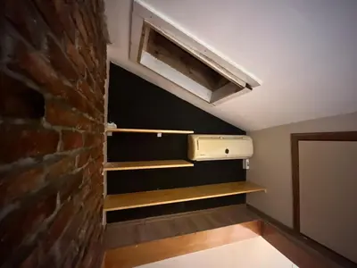 a room with a brick wall and an air conditioner at Wooden Villa in Istanbul