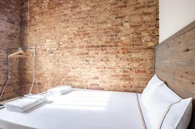 a white table in front of a brick wall at Grand Historic 3BD2Bath Galata Tower Pad! #408 in Istanbul