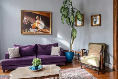 a living room with a purple couch and a painting at Grand Historic 3BD2Bath Galata Tower Pad! #408 in Istanbul