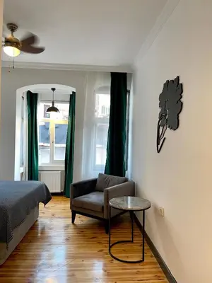 a bedroom with a bed and a chair and a table at Balat Homes & Apartments Nick in Istanbul