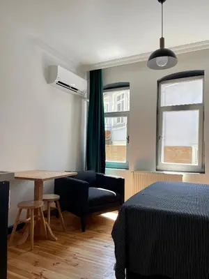 a room with a bed and a table and a couch at Balat Homes & Apartments Nick in Istanbul