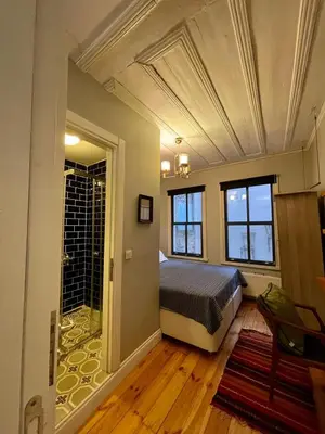 a bedroom with a bed in a room with a window at Balat Homes & Apartments Cottage in Istanbul