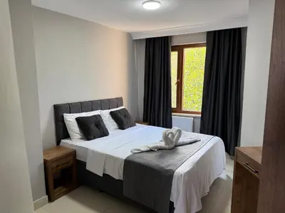 a bedroom with a bed and a window at Rumeli Pansiyon in Kumbağ