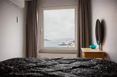 a bedroom with a window with a view of the ocean at Boğaz Yalı Dairesi in Istanbul