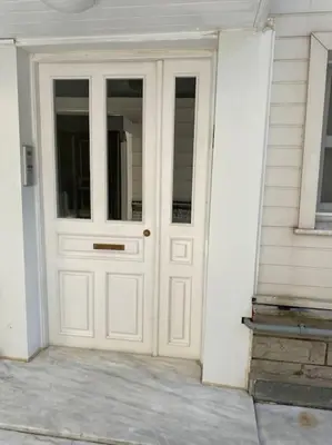 a white door on the side of a house at Boğaz Yalı Dairesi in Istanbul
