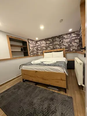 a bedroom with a bed and a brick wall at AYD Apartment Beyoğlu in Istanbul