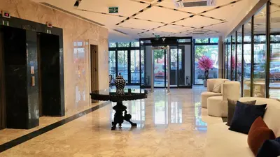 a lobby with a table in the middle of a building at Park Dedeman Sisli - Istanbul City Center in Istanbul