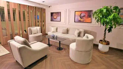 a living room with a couch and chairs and a potted plant at Park Dedeman Sisli - Istanbul City Center in Istanbul