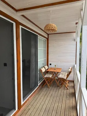 a wooden deck with a table and chairs on it at Doğayla İç içe Lüks Villa in İznik