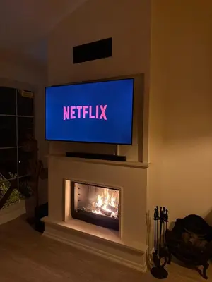 a television above a fireplace in a living room at Doğayla İç içe Lüks Villa in İznik