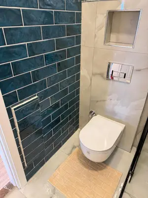 a bathroom with a toilet and blue tiles at Doğayla İç içe Lüks Villa in İznik