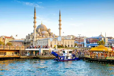 a boat in the water in front of a mosque at Sultan TG Hotel in Istanbul