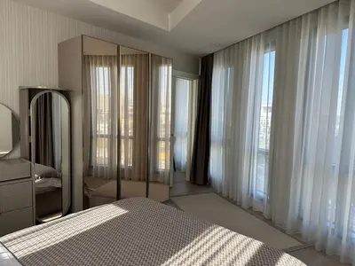 a bedroom with a bed and large windows at 91 sqm luxury apartment with double view in Istanbul
