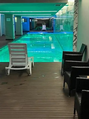 a swimming pool with a white chair in a building at 91 sqm luxury apartment with double view in Istanbul
