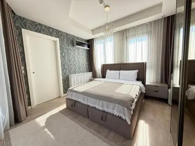 a bedroom with a bed and a large window at 91 sqm luxury apartment with double view in Istanbul