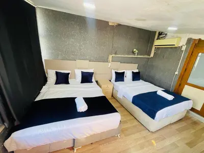 two beds in a small room with two beds sidx sidx sidx at Taksim Historic House hotel in Istanbul