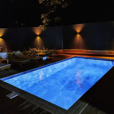 a swimming pool at night with a table and chairs at Nevbahar Sapanca ile Lüks Bir Tatile Merhaba Deyin in Sapanca