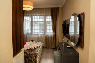 a hotel room with a bed and a mirror at Altuncu Premium Termal Hotel in Armutlu