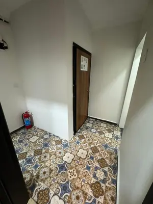 an empty room with a tile floor and a door at Asmaaltı GUEST HOUSE in Bursa