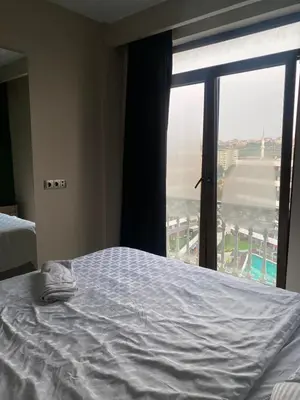 a bed in a hotel room with a large window at paradise hotel in Istanbul