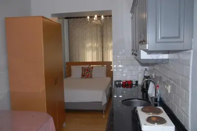a small kitchen with a bed and a sink at Ozcans Pera Flats 4 in Istanbul