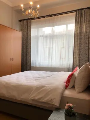 a bedroom with a large bed with a window at Ozcans Pera Flats 5 in Istanbul