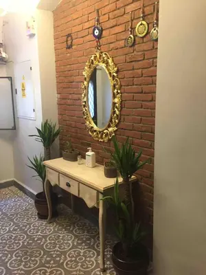 a bathroom with a mirror on a brick wall at Ozcans Pera Flats 5 in Istanbul