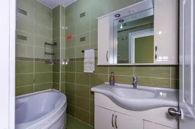 a bathroom with a sink and a toilet and a mirror at Şehir Manzaralı Ferah Daire in Istanbul